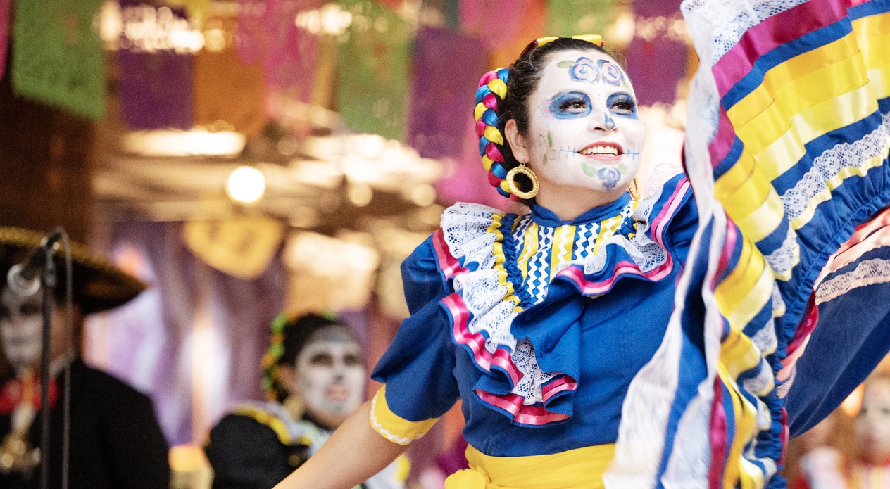 Woman dancing at dia de muertos at the museum 