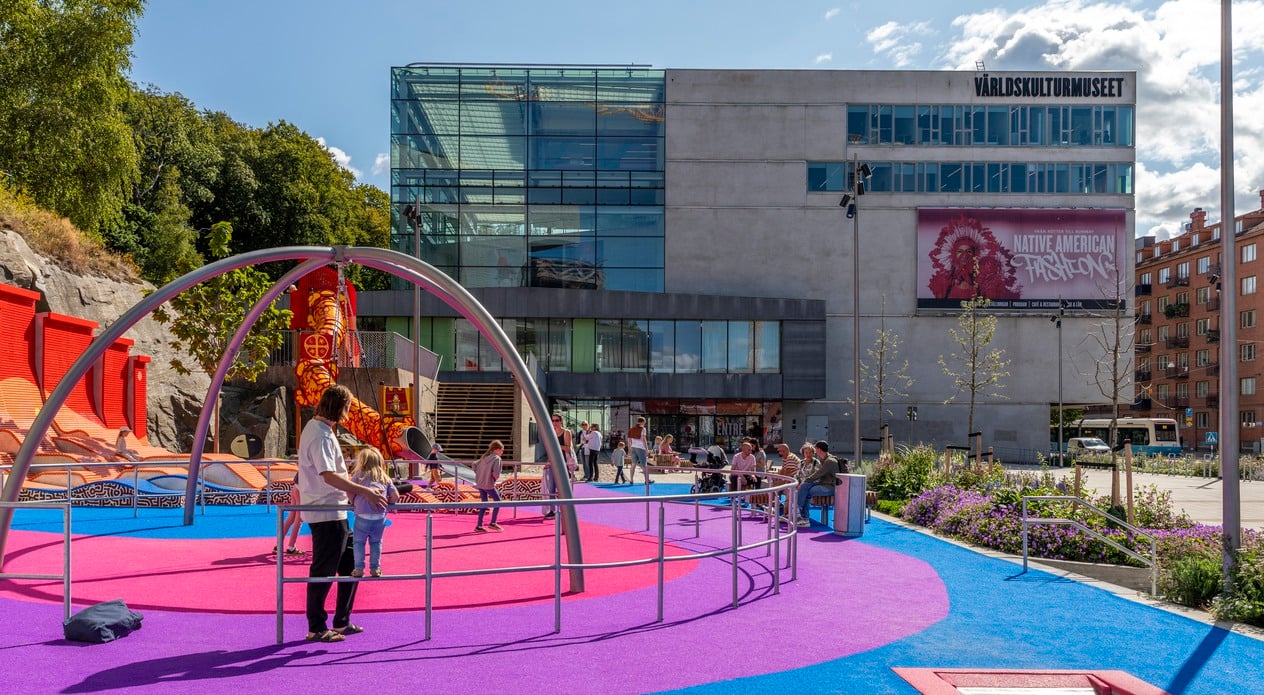 Förplatsen utanför Världskulturmuseets entré som är nyöppnad, barn och familjer leker och sitter på bänkar
